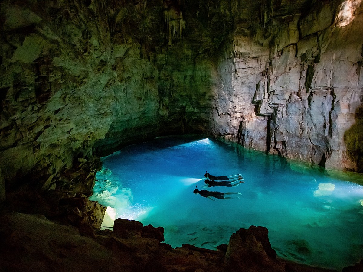 Clear blue water inside a limestone cave